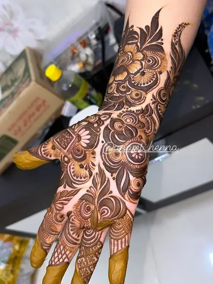 A clear, well-lit shot of a full bridal hand design. You can see the precision in every line and the depth created by the shading.