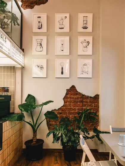 Details make the brand. At Stand By Coffee, I photographed this gallery wall of coffee-making illustrations next to the exposed brick, highlighting the cafe's passion for coffee culture and its rustic-modern aesthetic.