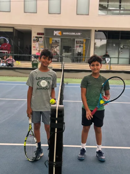 Two friends and players at the net. Our academy is a place where lasting friendships are forged on and off the court.