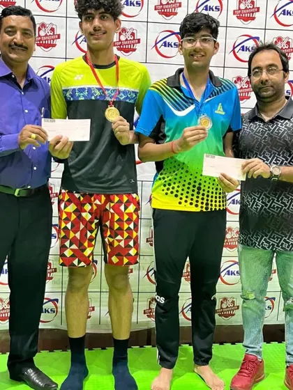 Presenting cash prizes and medals to the winners of a doubles tournament. I believe in rewarding the hard work and success of my players.