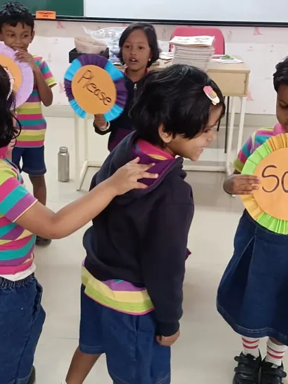 Learning the magic words! Students engage in a role-playing activity to practice saying 'Sorry' and 'Please', fostering kindness and good manners.