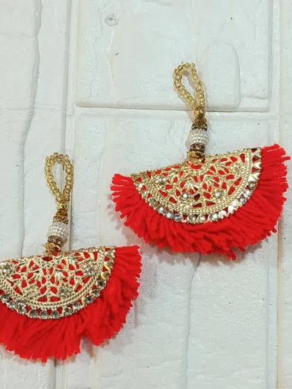 These red fan-shaped tassels are another vibrant option from our collection. Their intricate gold work adds a touch of elegance and festivity.