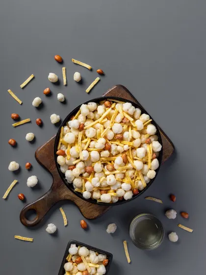 A light, savory mix featuring puffed rice and peanuts. The neutral grey background ensures the product's colors and textures are the primary focus for this packaging shot.