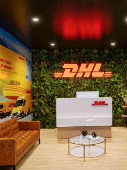 A 3D render of the DHL reception. This was our vision for a welcoming space that immediately communicates the brand's identity through the logo, a green wall, and brand-inspired graphics.