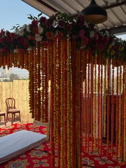 A different angle of the outdoor marigold mandap, showing how it looks against the open sky.