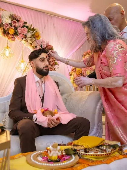 A family member blesses the groom during the Kurmai ceremony. It is a privilege for us to be a part of such significant family milestones.