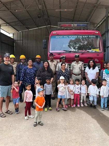 A proud group photo with the firefighters in front of their fire truck after an exciting and educational field trip.