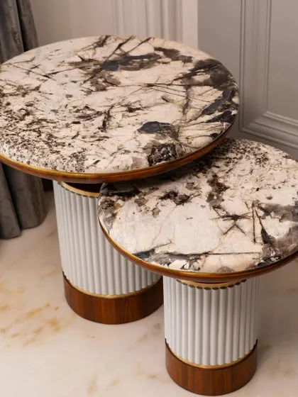 The new set of two side tables, featuring marble tops, wood finish, and brass details to enhance the living room's aura.
