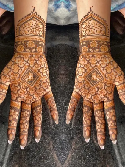 A full-hand design with elephant motifs, perfect for the festive season.