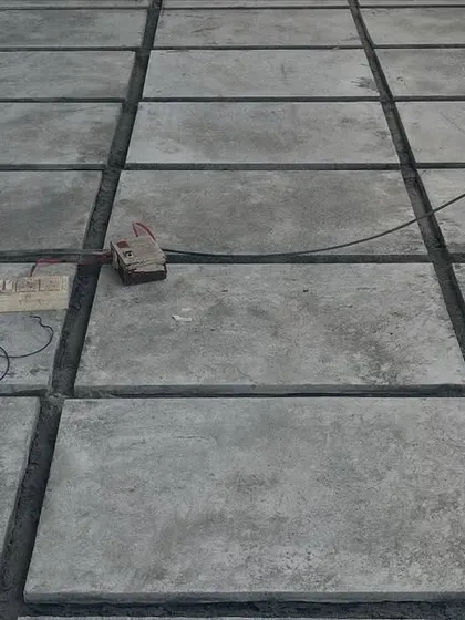 A nearly completed stone paver floor. This type of flooring is extremely durable and suitable for high-traffic areas like walkways and car parking spaces.