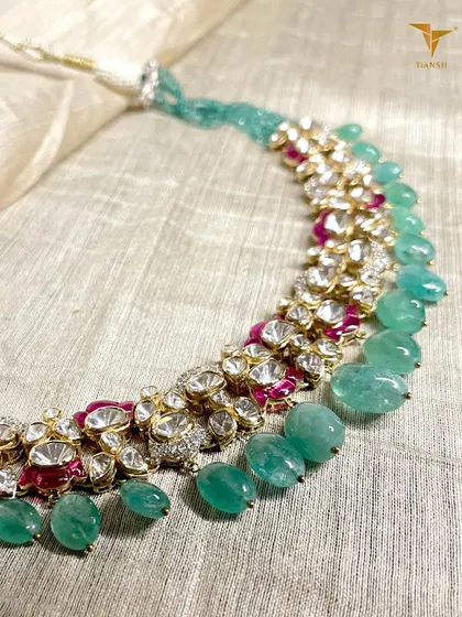 Because royalty is not a title, it is a state of mind. This regal necklace, woven in gold with Polki diamonds, deep rubies, and lush emeralds, is for the woman who commands attention with grace.