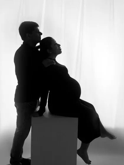 A powerful silhouette of a couple against a white background. This minimalist approach creates a striking and artistic image.