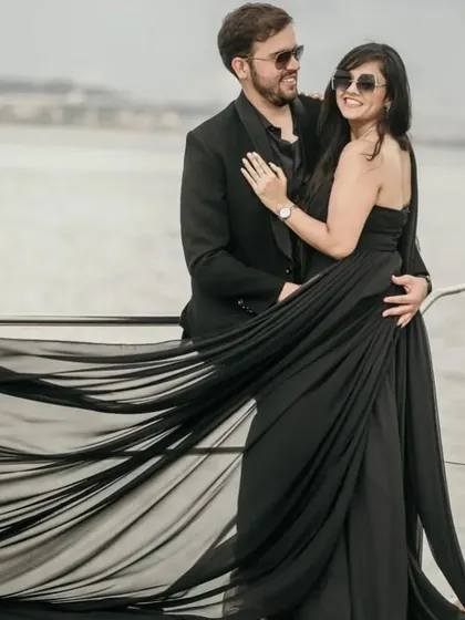 The long, flowing trails of our black gown create a stunning visual on this yacht photoshoot. It's a perfect choice for a chic and glamorous pre-wedding theme.