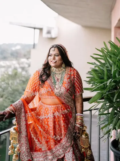 For her Sangeet, this bride chose a vibrant orange lehenga. The makeup was designed to be fun and glamorous, with a focus on eyes that would pop on the dance floor and makeup that would last all night.