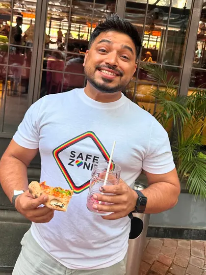 Enjoying a healthy snack and smoothie while wearing a "Safe Zone" t-shirt. We strive to create safe, welcoming spaces for everyone.