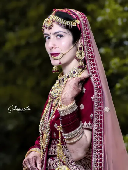 A classic portrait of a bride in her traditional Himachali wedding attire, looking elegant and serene.
