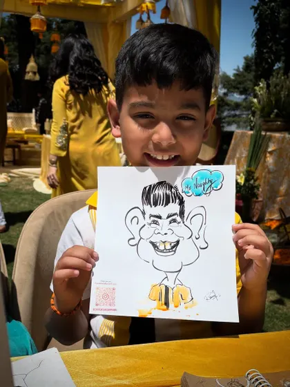 Even the youngest guests love getting their caricatures done. His happy face is just priceless.