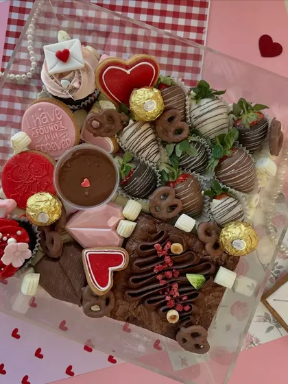 Our luxurious Valentine's Dessert Box is a curated collection of our best treats, including chocolate-covered strawberries, fudgy brownies, heart-shaped cookies, and mini cupcakes.