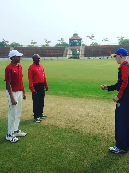 Our player stands ready for the coin toss, a key part of our U-19 cricket match experience. We focus on developing leaders who are calm and confident under pressure.