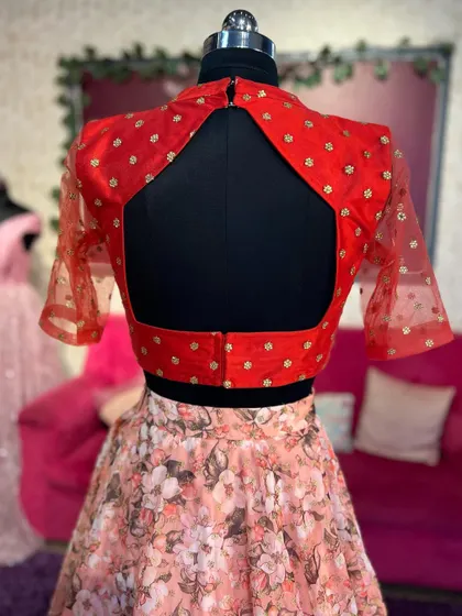 The back of the red blouse, featuring a stylish keyhole cutout design.