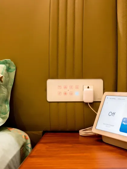 A bedside setup featuring our smart panel and a Google Nest Hub, allowing for both touch and voice control of the entire room.