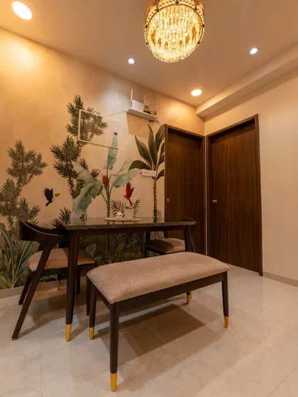 The dining area of the Pune home, where a nature-themed wallpaper creates a beautiful and intimate setting.