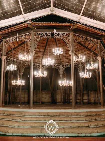 The stunning iron-wrought gazebo at The Tamarind Tree, decorated with elegant chandeliers for a cocktail night. This historic venue provides a perfect backdrop for a grand and romantic celebration.