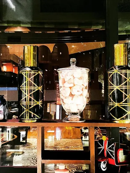 Decorative jars with golden geometric patterns used as part of a Diwali event decor. These small props add a touch of luxury and thematic consistency to food stations and shelves.