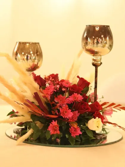 Another view of the elegant red and gold centerpiece, perfect for a glamorous evening reception.