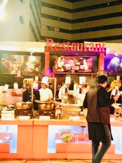 We can create a fully equipped live restaurant setup within your event. This station features multiple chefs, diverse dishes, and a professional backdrop, offering guests a complete dining experience.