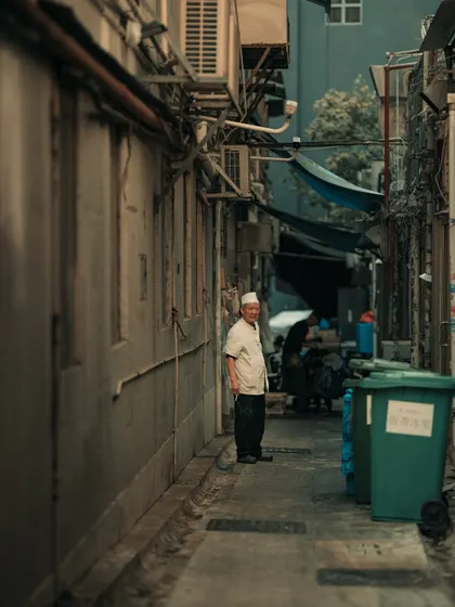 A worker in a narrow alleyway in Hong Kong. These hidden lanes often hold more character and untold stories than the main thoroughfares.