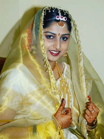 A portrait of a bride looking through her sheer veil, creating a soft and traditional look.