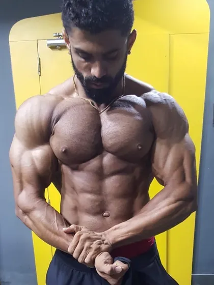 Capturing the gains in the gym mirror. This pose emphasizes chest striations and shoulder development, key components of a balanced, aesthetic physique.