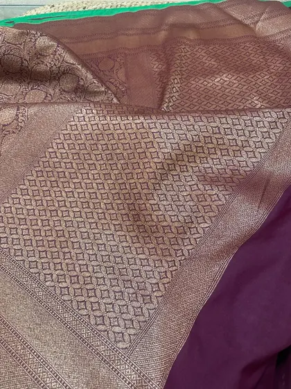 The complete look of this deep wine-purple Banarasi silk saree. The pallu features a beautiful diamond jaal weaving in a subtle, elegant design.
