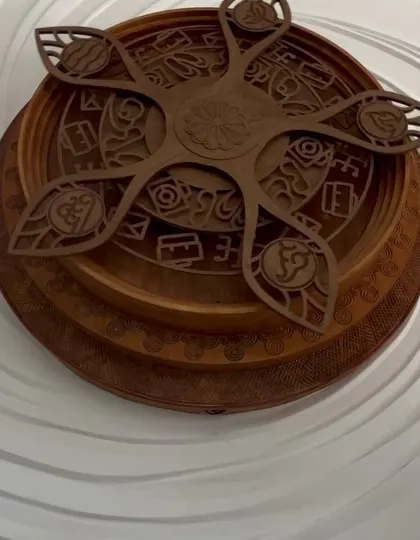 Detail is everything. This close-up highlights the craftsmanship of the wooden centerpiece, which was designed to complement the fluid, organic lines of the surrounding wall sculpture.
