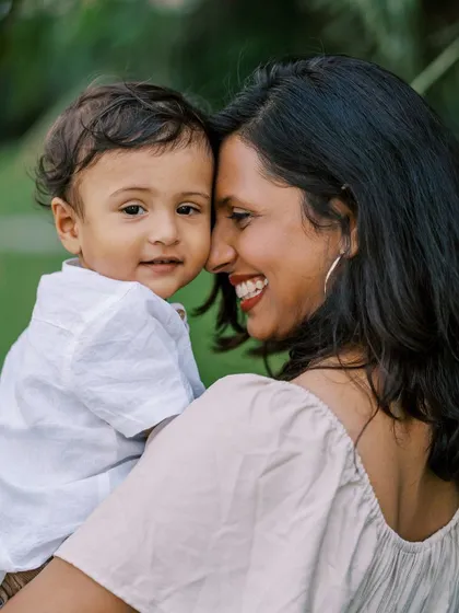 A mother and son sharing a close moment. The genuine connection and her bright smile make this a standout photo.