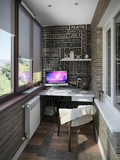 A creative and inspiring balcony office featuring a chalkboard-style wall with famous authors' names. This unique backdrop adds character to a functional workspace with a great view.