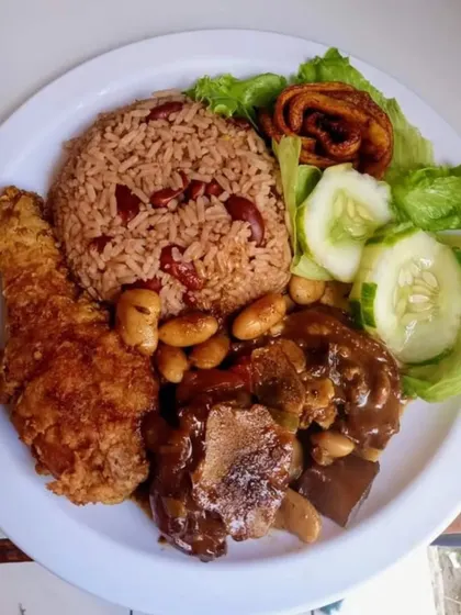 A hearty and wholesome meal plate with fried chicken, rice and beans, and a side of salad. We can cater to a variety of international cuisines.