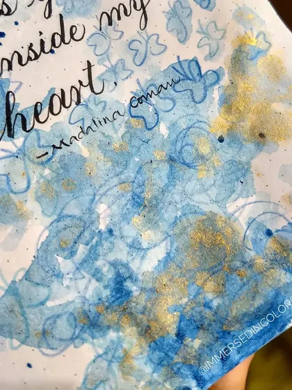 A close-up of the abstract butterfly piece, showing the shimmer of the gold watercolor mixed in with the blue. It almost looks like a galaxy of butterflies.