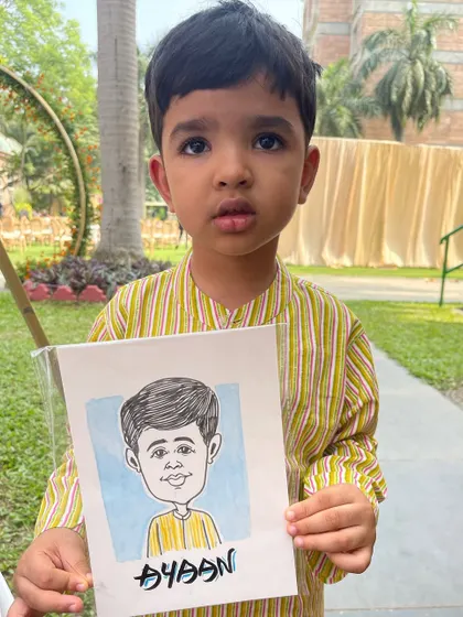 Even the youngest guests enjoy getting their caricature done. This little boy was thrilled with his portrait at a recent wedding, complete with a touch of colour.