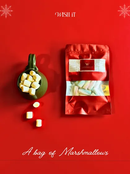 A cozy shot of a festive mug filled with marshmallows, a key component of our Holiday Crate for those curl-up-by-the-fire moments.