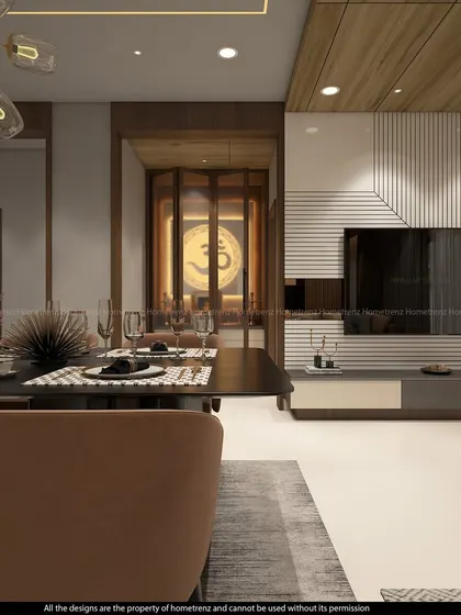 A view from the dining area towards a modern pooja room. The foldable, fluted glass doors with a large 'Om' symbol create a sense of reverence while maintaining a contemporary aesthetic.