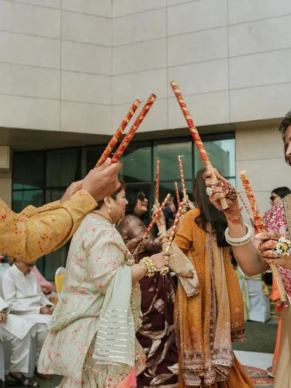Guests enjoy a round of Dandiya, an essential and fun part of any Gujarati wedding celebration.