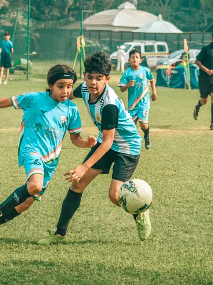 Intense focus from these young athletes as they battle for control of the midfield.