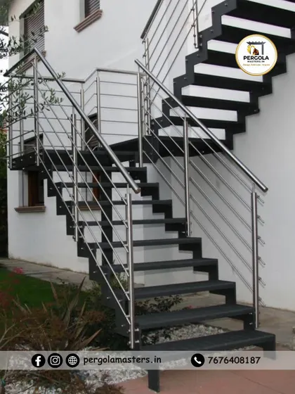 A modern exterior staircase combining a strong black metal frame with sleek stainless steel cable railings. This design offers a contemporary and minimalist aesthetic while ensuring safety and durability.