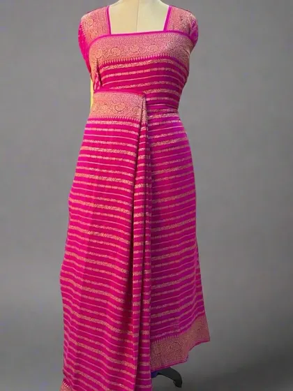 A mannequin draped in a beautiful pink pure Banaras crepe saree with stripes.