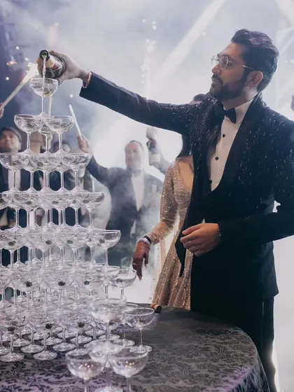 The groom kicks off the celebration with a champagne tower, a classic and glamorous moment that signals the start of a fun-filled cocktail night.