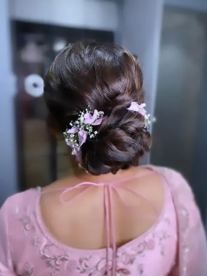 A back view of the mother of the bride's beautiful floral bun.