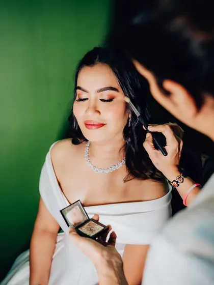 A behind-the-scenes look at the artistry. Applying eyeshadow to create a soft, blended look that enhances her beautiful eye shape.