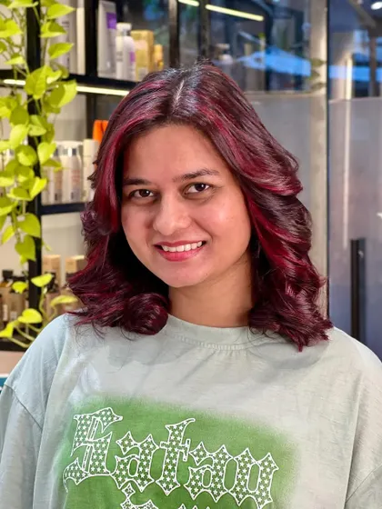 Seeing red and loving it. This client is all smiles with her new fiery look, which perfectly complements her skin tone.